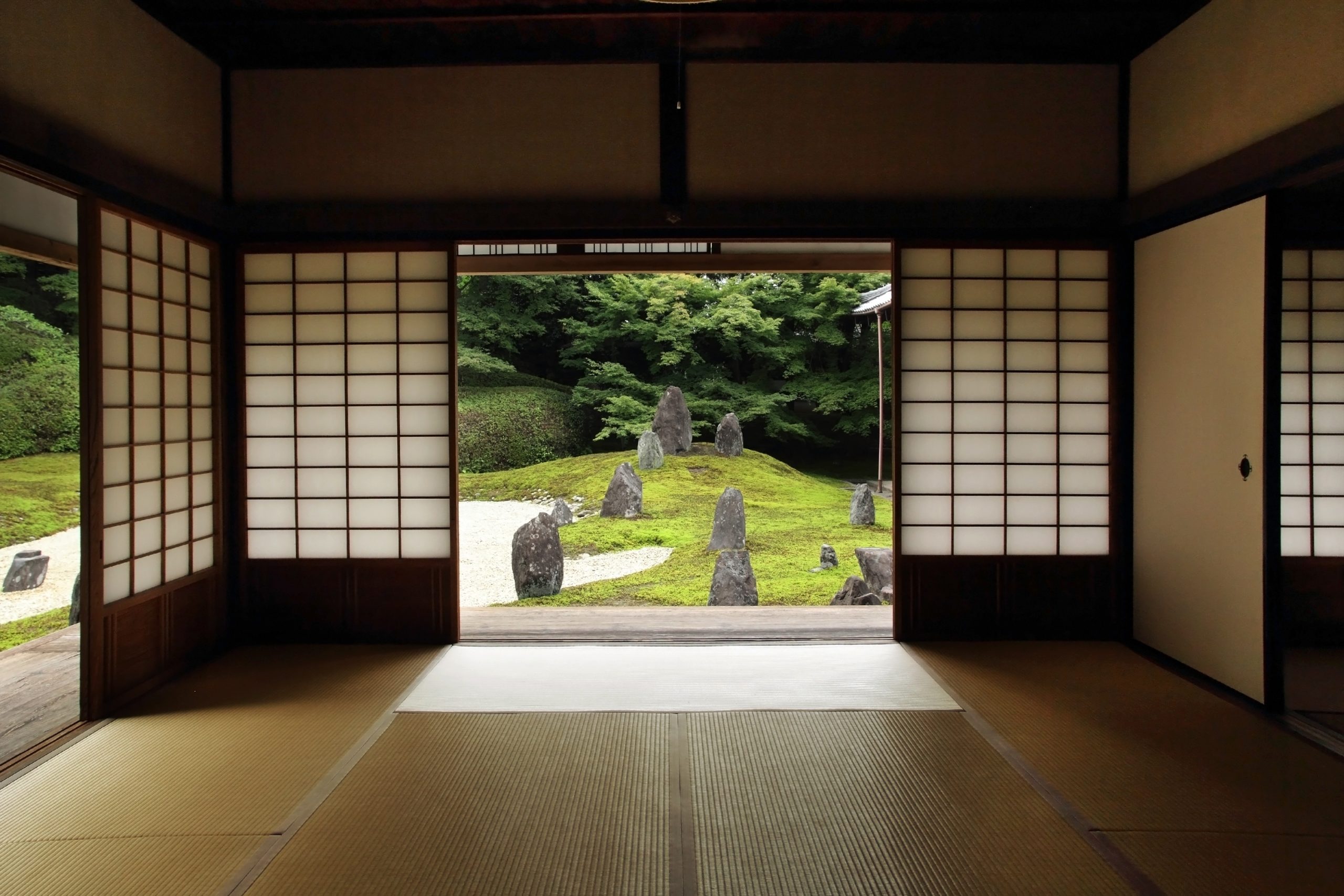 Vista desde el interior a un jardín con piedras minimalistas estilo oriental